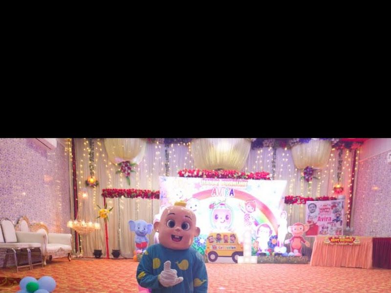 Character mascot add-on — a CoComelon mascot at a 1st-birthday hall — Arya Events Planner, Kharghar, Navi Mumbai