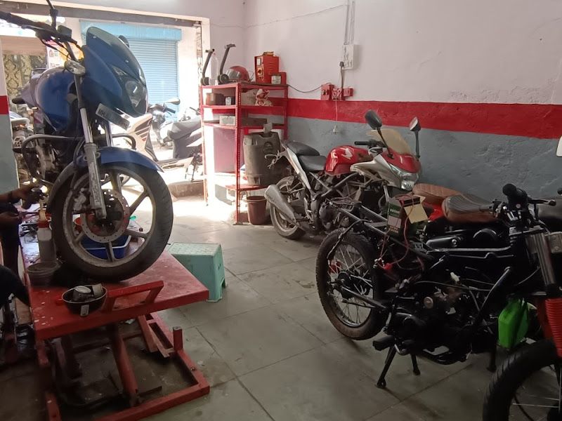 Technician servicing a bike on the lift, wide workshop view — The Bike Shoppy, Vashi, Navi Mumbai