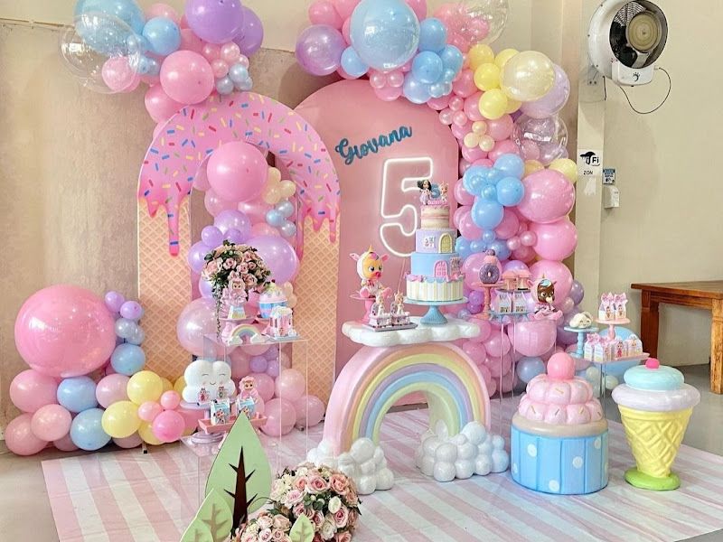 Candyland / ice-cream theme 5th birthday — pastel donut arches, rainbow, cupcake and ice-cream props with a tiered display — Arya Events Planner, Kharghar, Navi Mumbai