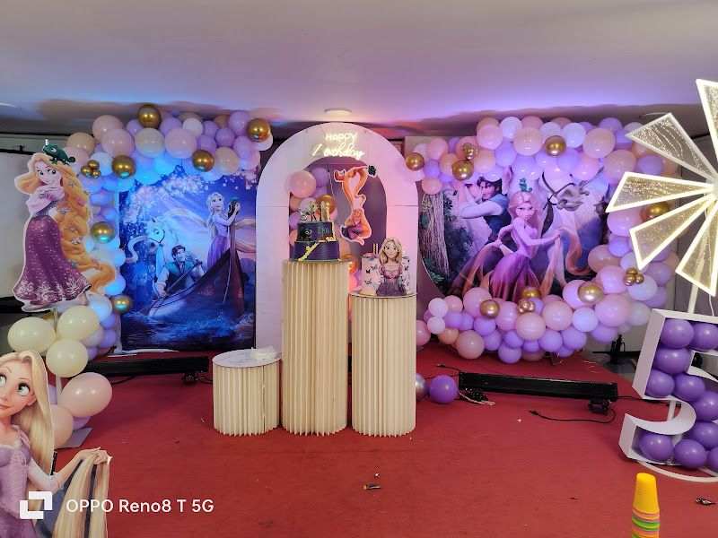 Rapunzel-theme balloon room decor — purple and cream balloon walls with princess cutouts and an arched centre backdrop — Arya Events Planner, Kharghar, Navi Mumbai