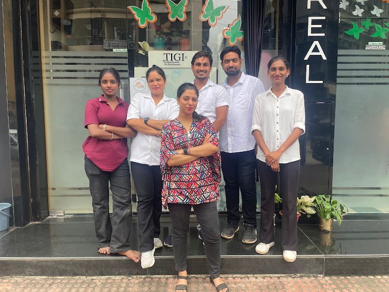 Group team photo — six staff members posed together at the salon entrance (the only clear posed full-team shot in the sample). — The Rush Family Salon, Airoli, Navi Mumbai
