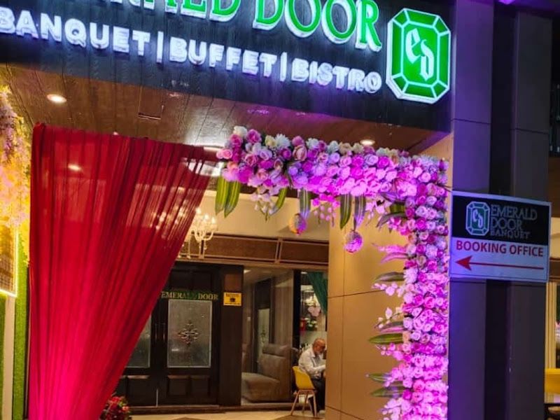 Venue entrance decor — magenta drape with cascading orchids and uplighting at a banquet entrance — Arya Events Planner, Kharghar, Navi Mumbai