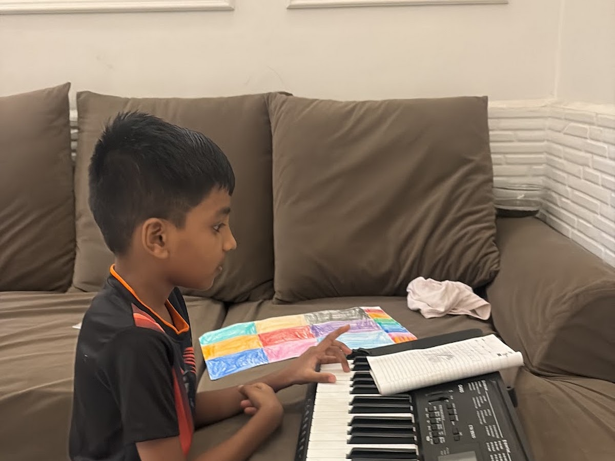 Student learning keyboard with personal guidance at String Nation Music World