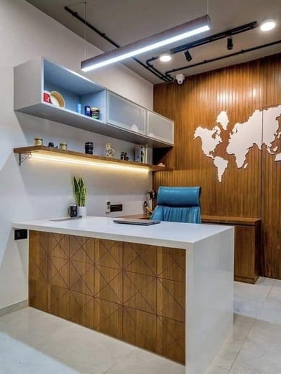 Reception desk with blue chair, shelves, pendant lights and world map wall panel