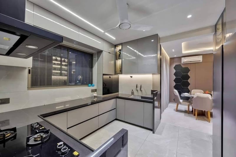 Modern kitchen and dining area with island cooktop, cabinetry and table seating