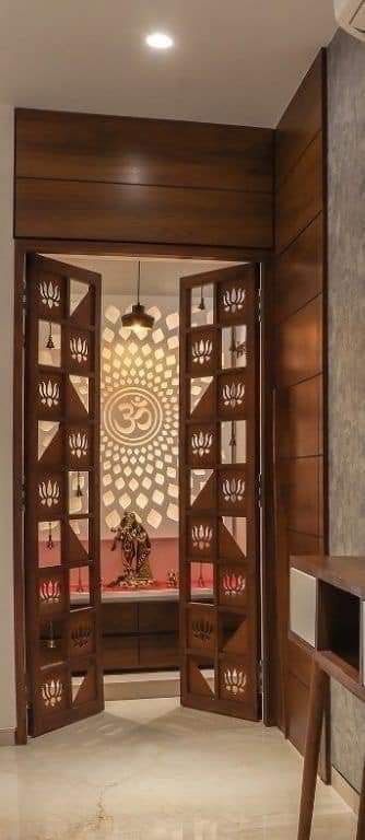 Open carved wooden doors leading to a decorative patterned interior space