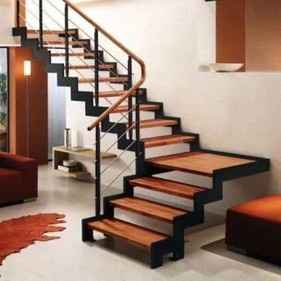 Modern interior with floating wooden staircase, black railing and wall-mounted fireplace